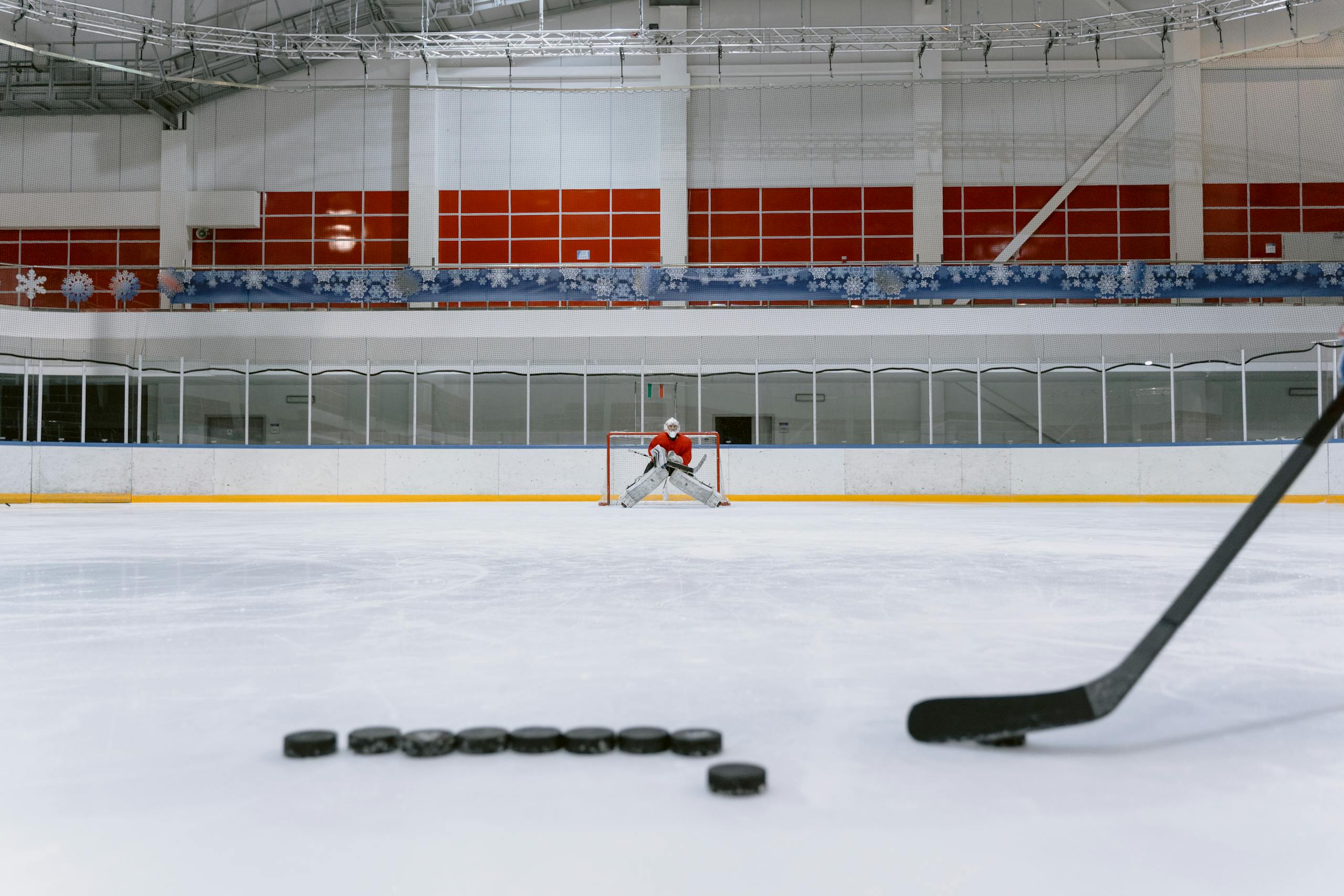 People Playing Ice Hockey on Ice Stadium